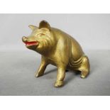 A vintage, cast iron, novelty money bank in the form of a seated pig by A.C.