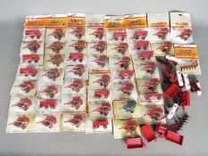 Ertl - Over 40 predominately carded 1:64 diecast farm implements from Ertl.