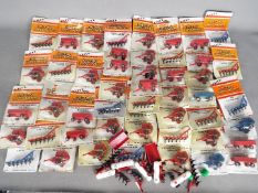 Ertl - Over 40 predominately carded 1:64 diecast farm implements from Ertl.