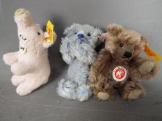 Steiff - three Steiff soft toys to include a pig #112034 with button and yellow tag,