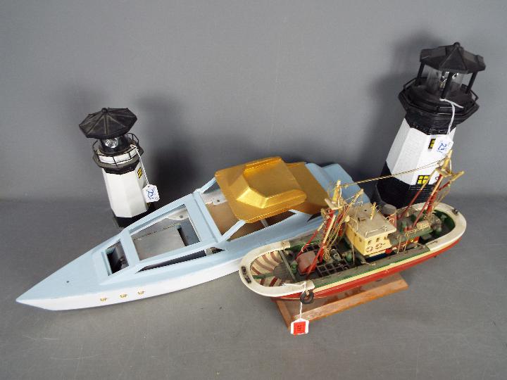 An unmarked wooden static display model of a barge,