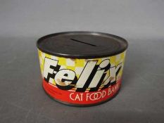 A vintage, novelty, money bank in the form of a tin of 'Felix Cat Food',