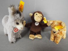Steiff - three Steiff animals to include a Monkey #112119, a cat #112089 and a donkey #052866,