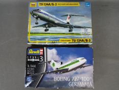 Zvezda, Revell - Two boxed passenger jet model kits in 1:144 scale.