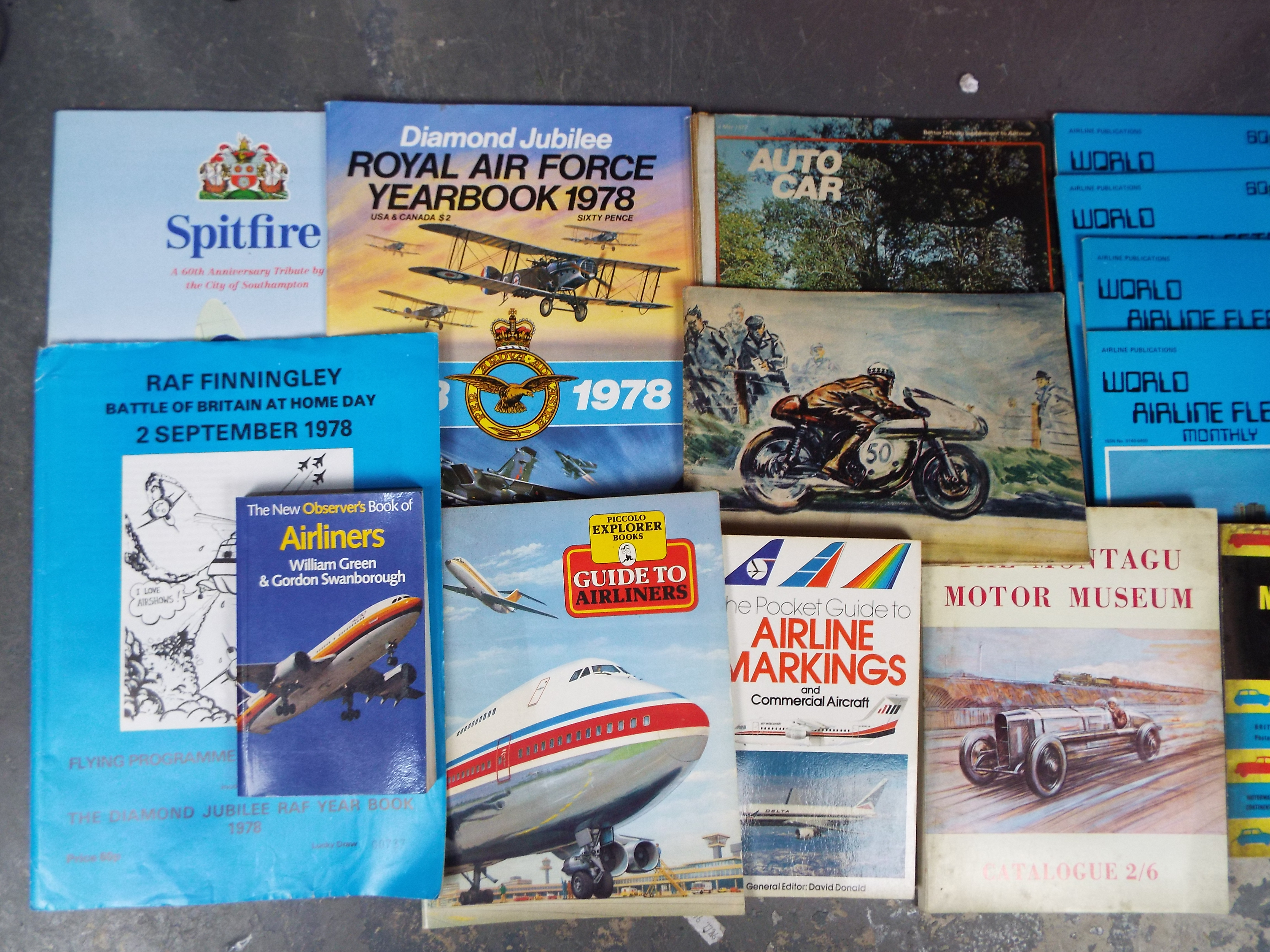 A large collection of hardback and paperback books relating to aircraft and airlines,