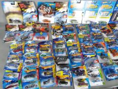 Hot Wheels - A collection of over 60 unopened Hot Wheels vehicles including # X1904 Mini Countyrman