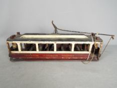 A scratch built wooden model of a single deck Liverpool Corporation Tramcar.