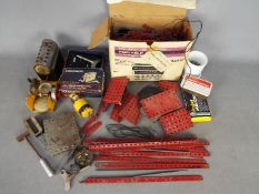 Meccano - A collection of Meccano parts including steam engine parts and a boxed clockwork motor.