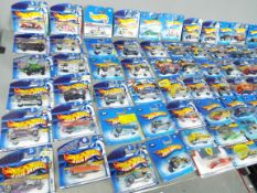 Hot Wheels - A collection of over 70 unopened Hot Wheels vehicles including # 161 Baja Bug,