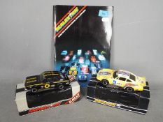 Scalextric - Two boxed vintage Scalextric cars with a 20th Edition Scalextric catalogue.