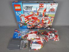 LEGO - # 7945 City Fire Station set in an open box with the parts in zip lock bags so it is