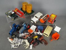 Britains - An unboxed collection of farm vehicles and implements by Britains.