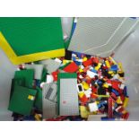 LEGO - A large quantity of loose Lego bricks presented in a large plastic container.