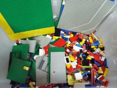 LEGO - A large quantity of loose Lego bricks presented in a large plastic container.