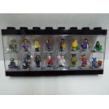 LEGO - A black plastic Lego display case in black containing 16 Lego 'Superheroes' themed