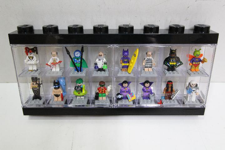 LEGO - A black plastic Lego display case in black containing 16 Lego 'Batman' themed minifigures.
