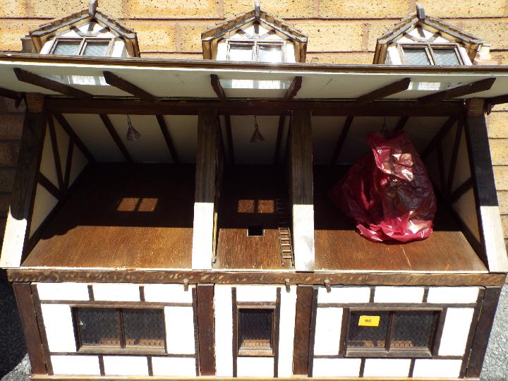 An illuminated hand built wooden three storey Tudor style dolls house, - Image 3 of 4