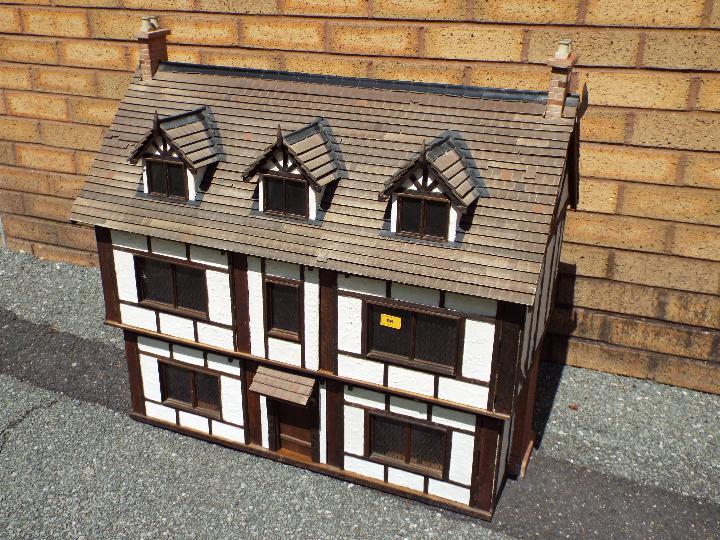 An illuminated hand built wooden three storey Tudor style dolls house, - Image 2 of 4