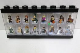 LEGO - A black plastic Lego display case in black containing 16 Lego 'Harry Potter' minifigures.