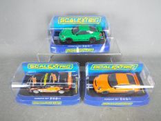 Scalextric - 3 x Porsche 997 slot cars, # C2871 GT3 RS in orange, # C3074 GT3 RS in green,