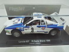 Flyslot - Lancia 037 Costa Brava Rally 1986 car in a perspex display case. # 046101.