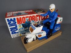 Min Yin - A vintage boxed plastic Police Electronic Stunt Motorcycle by Min Yin Toys .