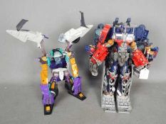 Hasbro - Transformers - 2 unboxed Hasbro Takara Transformer models dated 2004,