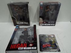 McFarlane Toys - A boxed collection of four 'The Walking Dead' action figures .