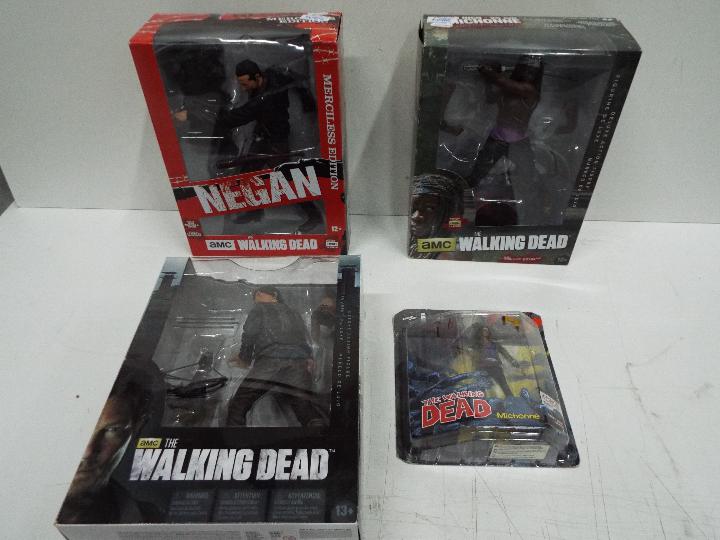McFarlane Toys - A boxed collection of four 'The Walking Dead' action figures .