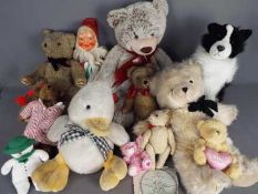 A collection of unboxed vintage dolls and mainly soft toys.