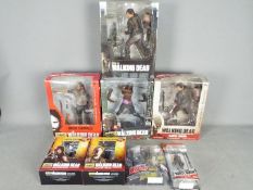 Eaglemoss; McFarlane - A boxed collection of 'The Walking Dead' action figures in various sizes.