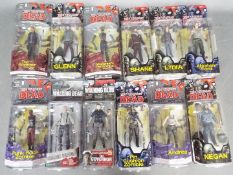 McFarlane Toys - A collection of 12 boxed 'The Walking Dead' action figures from McFarlane Toys.