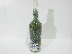 Marbles - A large glass half gallon King John Scotch Whisky bottle full of vintage marbles in Good