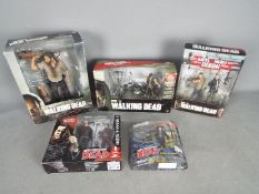 McFarlane Toys - Five boxed 'The Walking Dead' action figures from McFarlane Toys.