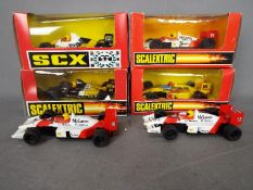 Scalextric - SCX - A group of 6 x Formula 1 slot cars including 2 x loose McLaren MP4,