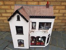 A scratch built wooden two storey dolls house.