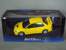 Autoart - A boxed 1:18 scale Mitsubishi Lancer Evolution VII in yellow,