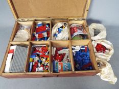LEGO - A wooden box containing a large quantity of loose vintage Lego bricks and parts.