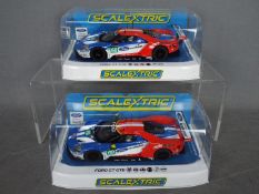 Scalextric - 2 x Ford GT GTE Le Mans cars in matching livery with consecutive numbers.