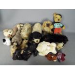 A family of 14 vintage and modern teddy bears and soft animal toys.