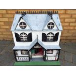 A scratch built wooden two storey dolls house.