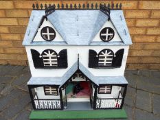 A scratch built wooden two storey dolls house.