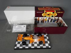 Carousel - A boxed 1:18 scale McLaren M16 1974 Indianapolis 500 winner number 3 Johnny Rutherford