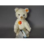 Steiff - An unboxed Steiff white plush bear #022739, standing approximately 26cms in height.