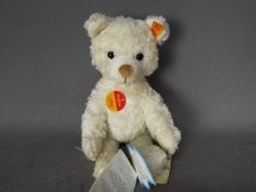 Steiff - An unboxed Steiff white plush bear #022739, standing approximately 26cms in height.