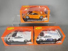 Slot-it - 3 x McLaren F1 GTR models in various liveries including orange road car trim and a white