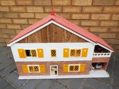 A scratch built wooden two storey 'Swiss' style dolls house.