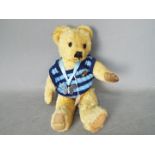 Merrythought - A fully jointed golden mohair bear with black and amber glass eyes.