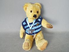 Merrythought - A fully jointed golden mohair bear with black and amber glass eyes.