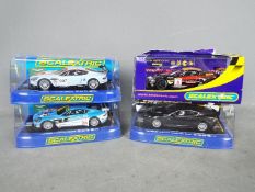 Scalextric - A collection of 4 x Aston Martin DBS and DBR9 models including a Top Gear car,